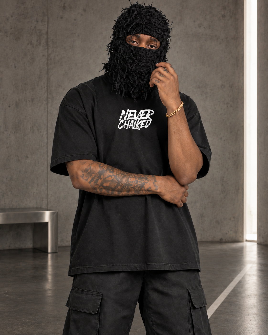 Front view of the Never Chalked Classic Heavyweight Tee styled with black cargos and a frayed ski mask in the Next Move set.